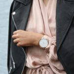 How to Choose the Right Jacket for You Stylish woman in a leather jacket showcasing an elegant wristwatch, perfect for fashion-forward individuals.